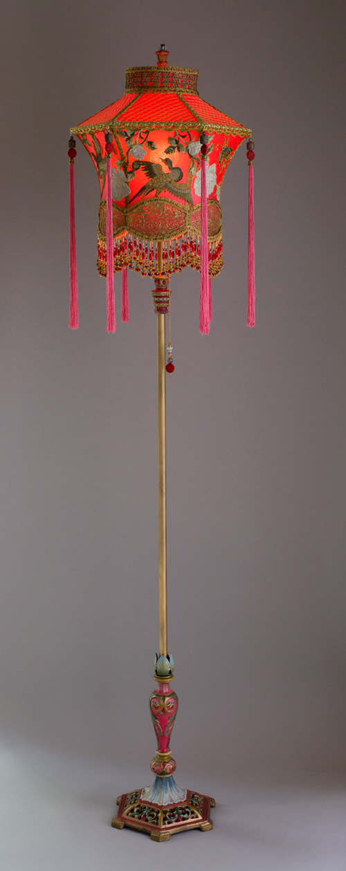 1920s antique floor lamp with scrolls has been hand painted and holds a hand-dyed exotic Chinoiserie Red Lantern with Cranes silk lampshade. 