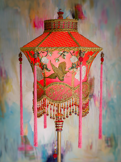 1920s antique floor lamp with scrolls has been hand painted and holds a hand-dyed exotic Chinoiserie Red Lantern with Cranes silk lampshade. 